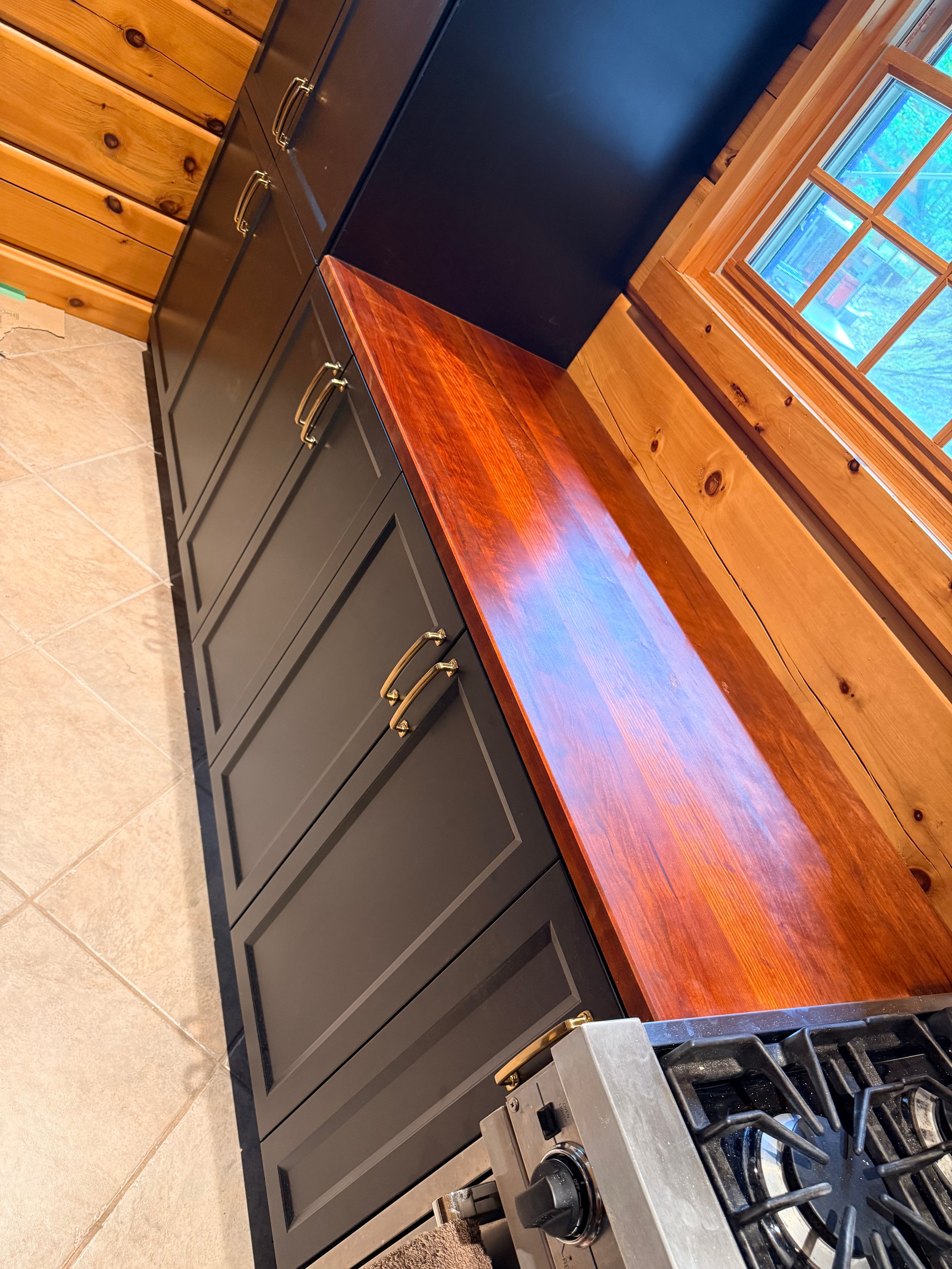 Reclaimed wood kitchen countertop with black cabinetry