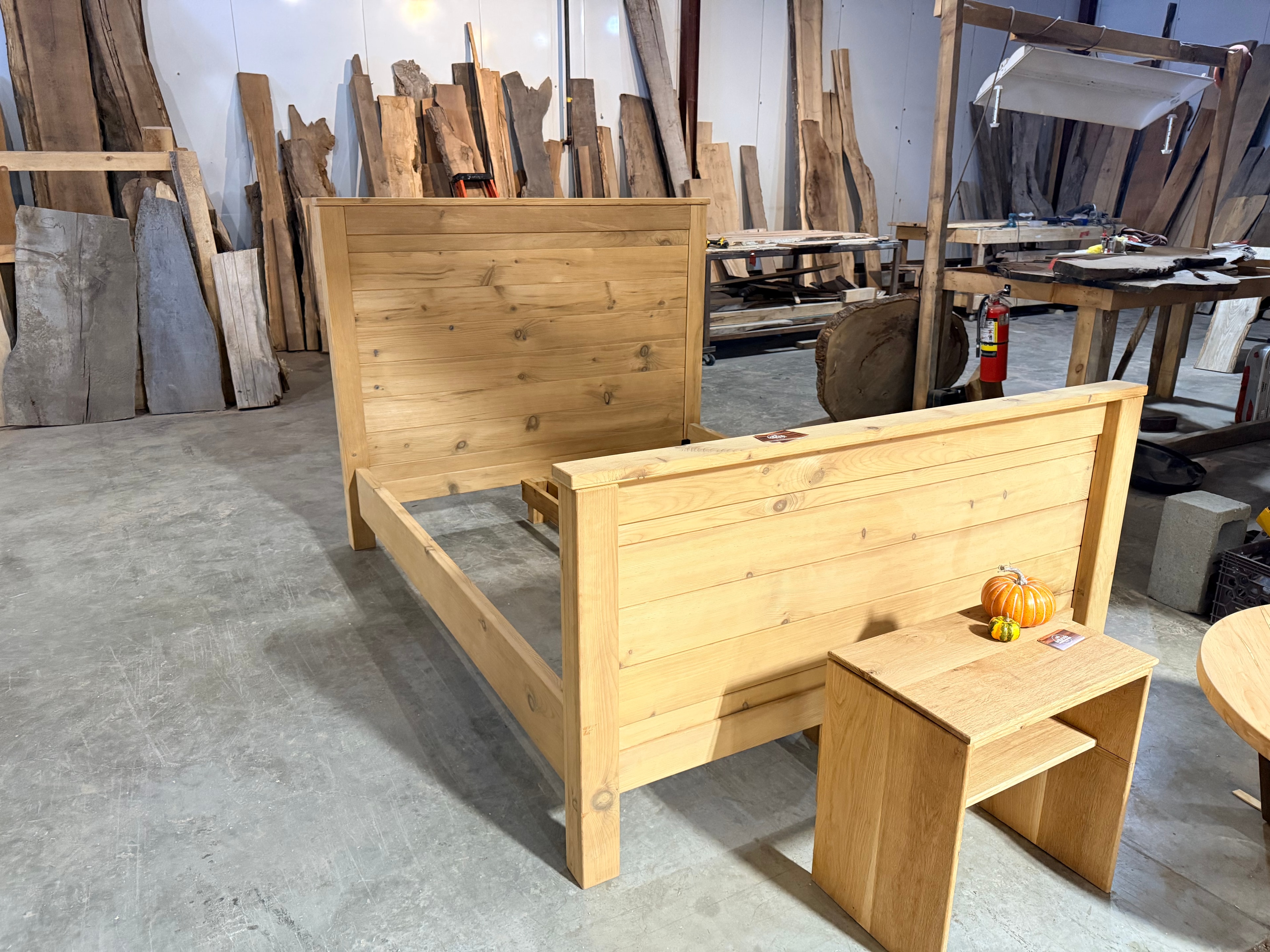 Handcrafted pine bed frame and nightstand in workshop